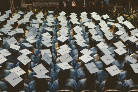 view from above of a group of graduates in gowns and mortar boards